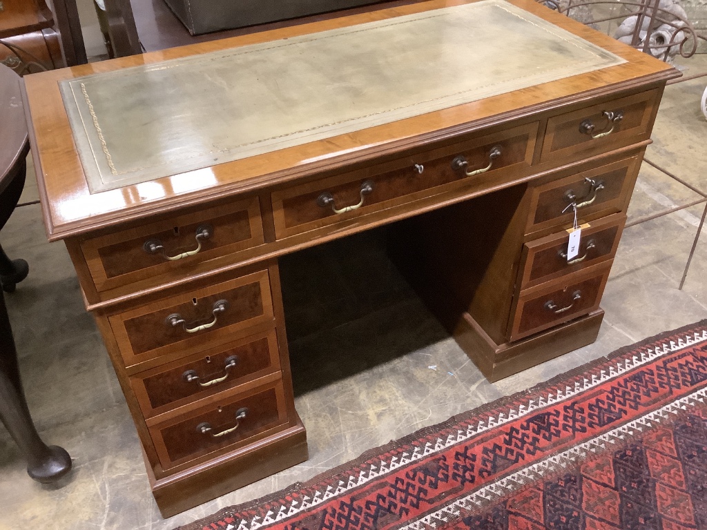 A reproduction inlaid mahogany pedestal desk, width 122cm, depth 61cm, height 80cm together with a mahogany swivel desk chair